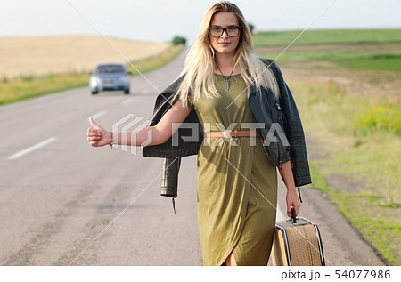 Portrait of a lady standing by the road. Portrait of a lady standing by the road. 54077986