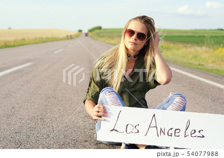 Beautiful Girl Hitchhiking On The Road Traveling. Beautiful Girl Hitchhiking On The Road Traveling. 54077988