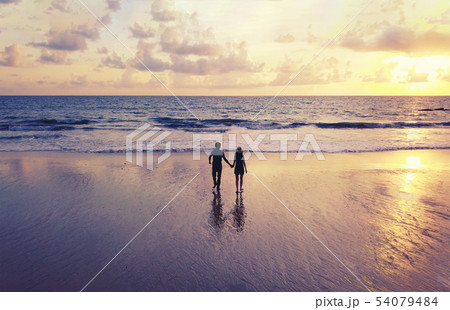 Happy Asian couple dating at the beach during Happy Asian couple dating at the beach during 54079484