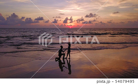 Happy Asian couple dating at the beach during Happy Asian couple dating at the beach during 54079495