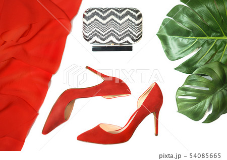 Top view party outfit red shoes accessories clutch tropical monstera leaves on white background, 54085665