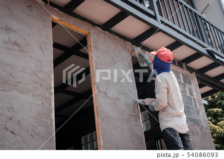 Construction workers plastering building wall Construction workers plastering building wall 54086093