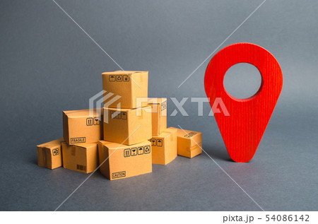A pile of cardboard boxes and a red position pin 54086142