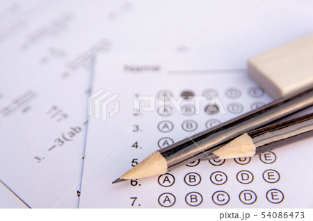 Pencil and eraser on answer sheets or Standardized 54086473