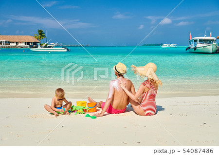 Family with three year old boy on beach Family with three year old boy on beach 54087486
