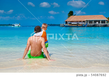 Toddler boy on beach with father 54087692