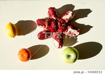 Garnet. Lemon. An Apple. Mandarin. Pomegranate. Grains pomegranate fruit. 54088352