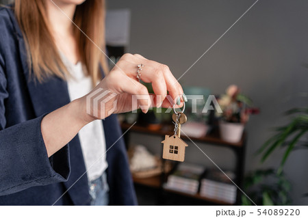 Concept of renting an apartment. House key in womans hands. Young woman. Modern light lobby interior 54089220
