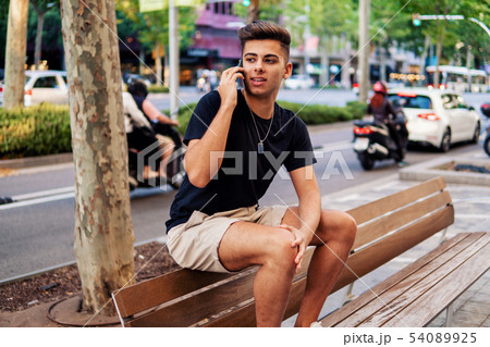 man on the street talking on a cell phone 54089925