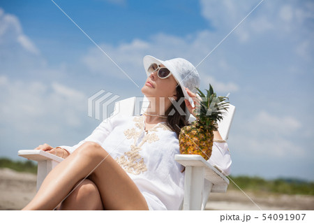 Woman relaxing at a paradisiac tropical beach 54091907