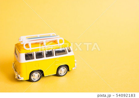 Funny yellow retro car with surfboard  54092183