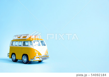 Funny yellow retro car with surfboard  54092184