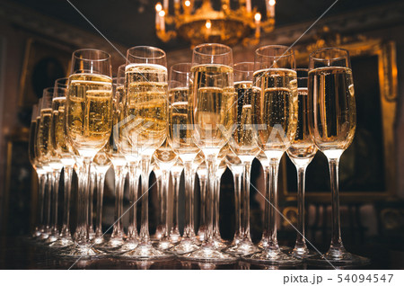 A lot of glasses of champagne in a luxurious 54094547