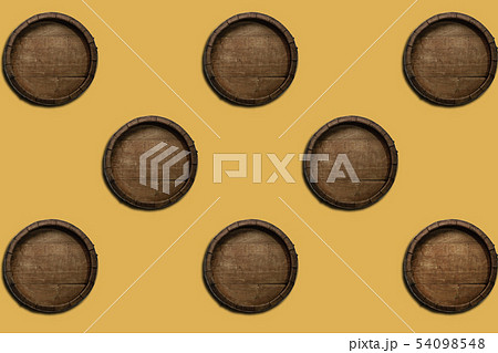 Beautiful old wooden barrels on a creative yellow Beautiful old wooden barrels on a creative yellow 54098548