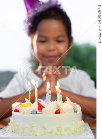 girl make folded hand to wish for her birthday girl make folded hand to wish for her birthday 54098943