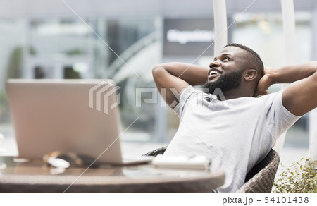 Young african american freelancer guy enjoying sunny day 54101438