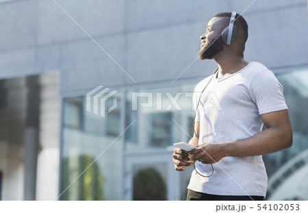 Young thoughtful african american guy walking outdoor 54102053