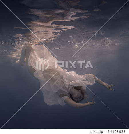 Woman in a white dress under water 54103023
