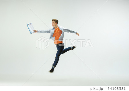 Man working at office and jumping isolated on studio background 54103581
