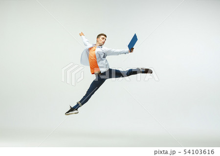 Man working at office and jumping isolated on studio background 54103616