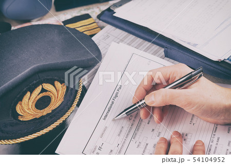Airplane pilot filling in flight plan 54104952