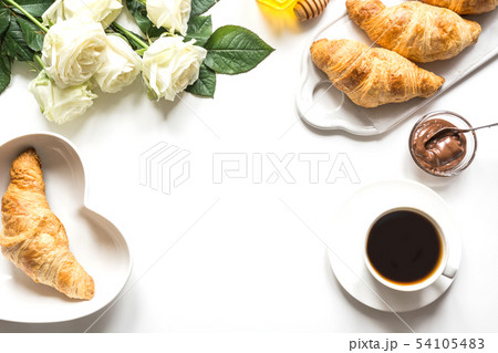Cup of coffee and freshly baked croissants. Cup of coffee and freshly baked croissants. 54105483