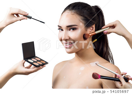 Young woman with vitilio among hands with make-up brushes. Young woman with vitilio among hands with make-up brushes. 54105697