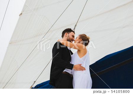 Couple of young people kissing on yacht 54105800