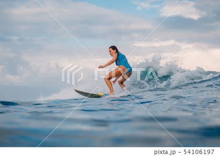 Surf girl on surfboard. Woman in ocean during surf Surf girl on surfboard. Woman in ocean during surf 54106197