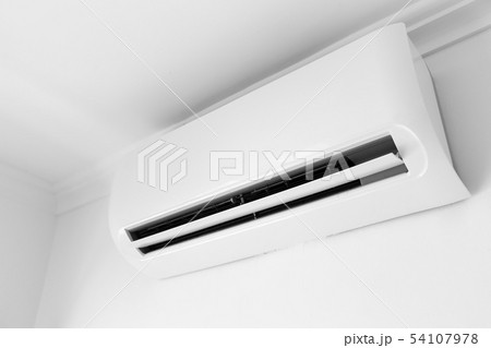 Flat air conditioner on white wall in room 54107978