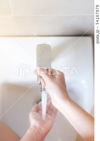 Woman taking hygiene shower with bidet 54107979