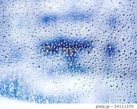 Rain drops on blue glass. Rain drops on blue glass. 54111370