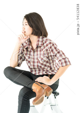 Young woman in a plaid shirt posing in studio on Young woman in a plaid shirt posing in studio on 54112838