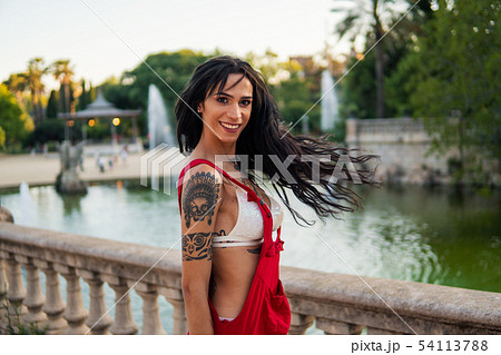 Ladyboy tattooed transgender model is dancing in the green park 54113788
