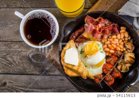 Full english breakfast - eggs, bacon, beans, toast, coffee and juice Full english breakfast - eggs, bacon, beans, toast, coffee and juice 54115613