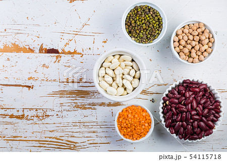 Selection of colorful beans on white wood background Selection of colorful beans on white wood background 54115718