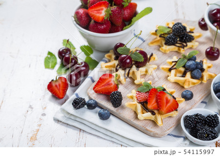 Colorful waffles with different berries Colorful waffles with different berries 54115997