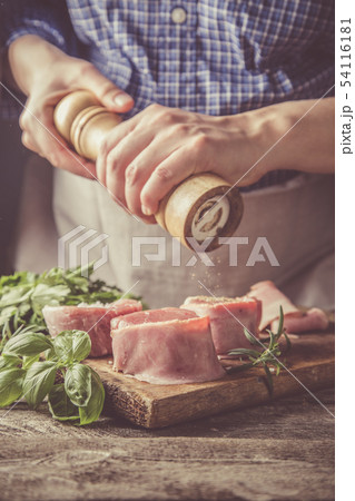 Preparing filet mignon - hands seasoning the steak Preparing filet mignon - hands seasoning the steak 54116181