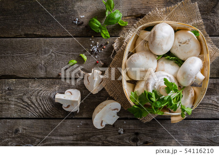 Mushrooms on rustic wood background 54116210