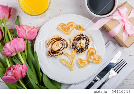 Mother's day breakfast concept - pancakes, coffee, flowers, present Mother's day breakfast concept - pancakes, coffee, flowers, present 54116212