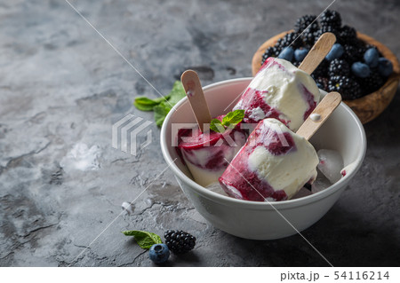 Berry popsicles on rustic background Berry popsicles on rustic background 54116214