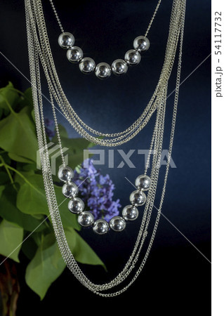 Two strings of round shiny beads and many thin 54117732