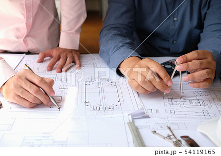 architect engineer team working on house blueprint of real estate project at workplace. construction & building concept architect engineer team working on house blueprint of real estate project at workplace. construction & building concept 54119165