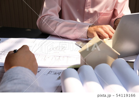 architect engineer team working on house blueprint of real estate project at workplace. construction & building concept architect engineer team working on house blueprint of real estate project at workplace. construction & building concept 54119166