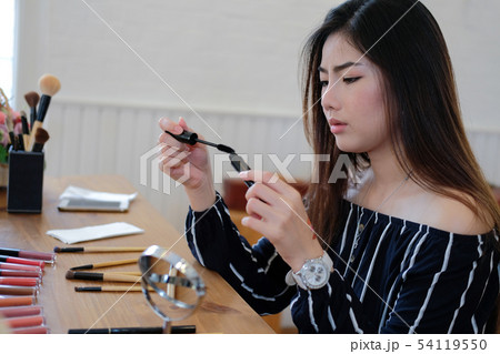 asian woman applying makeup cosmetic 54119550