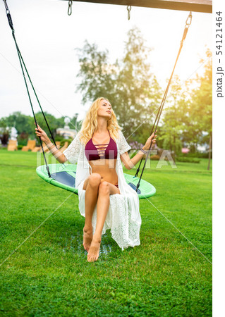 Youmg beautiful woman in beautiful summer garden Youmg beautiful woman in beautiful summer garden 54121464
