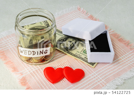 Wedding word, coins and dollar bill in a glass jar 54122725