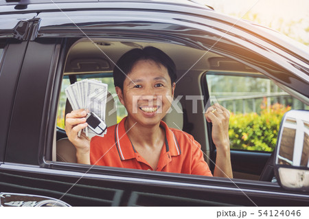 Man showing keys from car and dollar bunch Man showing keys from car and dollar bunch 54124046