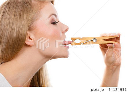 Blonde woman having tongue in clothespin 54124951