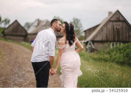 Groom kiss his beautiful bride. Couple walking in mountains Groom kiss his beautiful bride. Couple walking in mountains 54125910